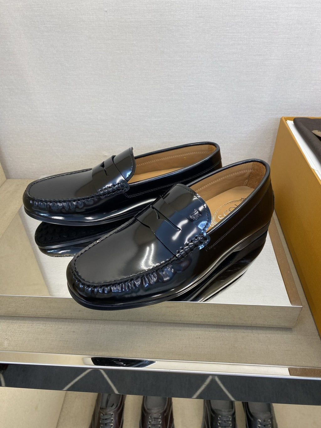 Tod's Glossy Dark Navy Penny Loafers — side